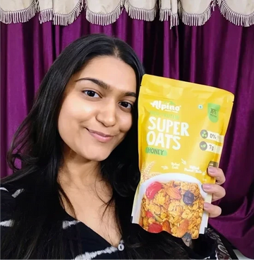 Khushi holding alpino super oats honey flavour